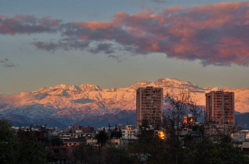 snowy mountain range, city, sunset