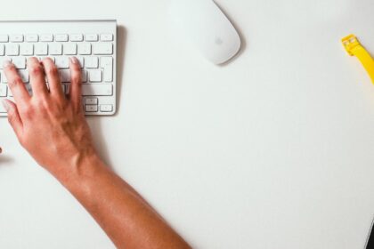 person typing on Apple Cordless Keyboard